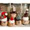Here is a group of handmade Christmas gourds. Each elf has a custom hat and a cute elf facial expression carved out of their gourd shell. 